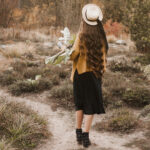 Girl with flowers on hand.