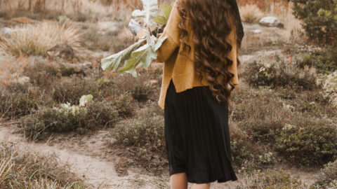 Girl with flowers on hand.